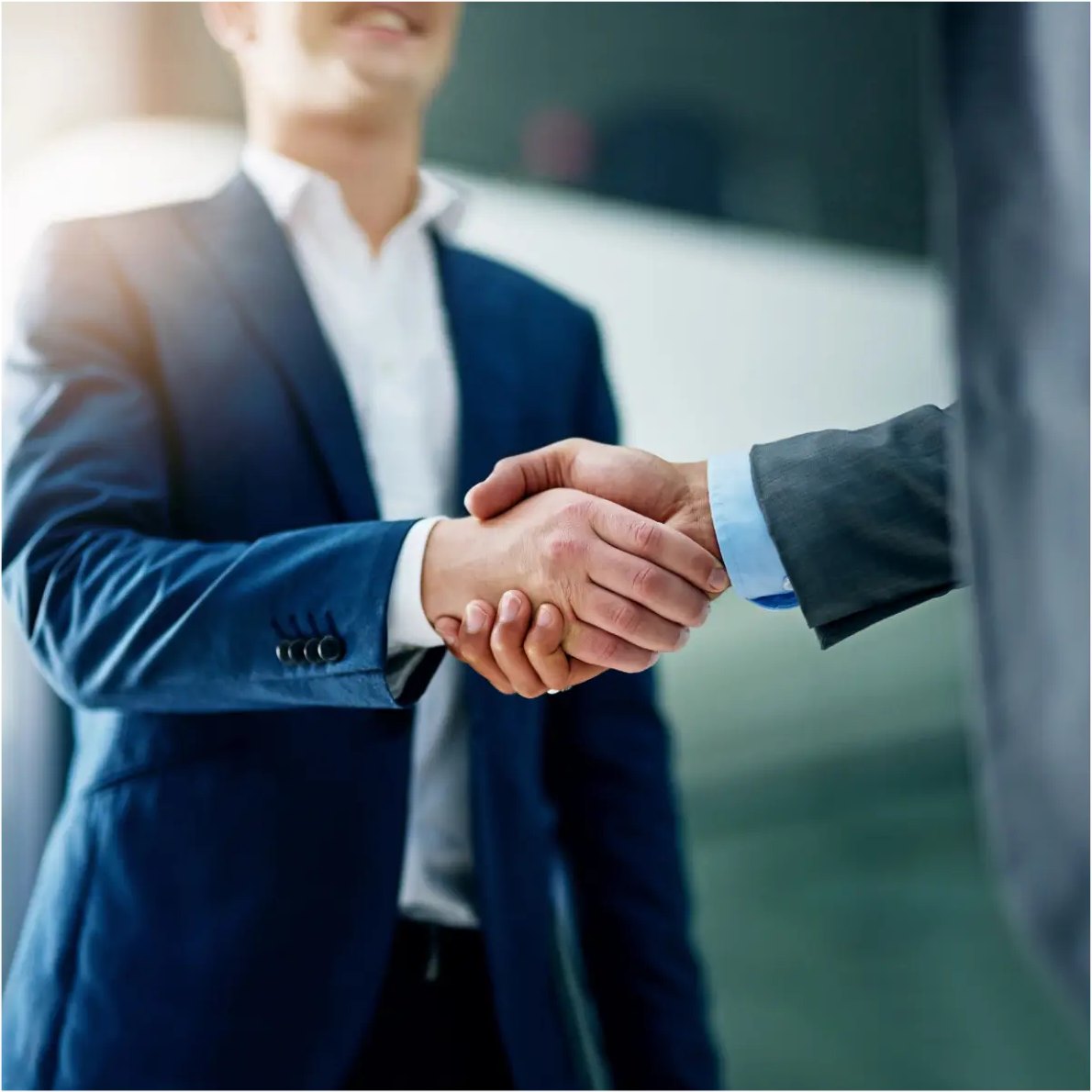 Two professionals shaking hands to confirm a hiring agreement