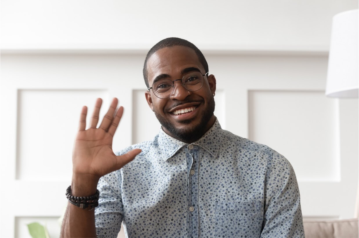Recruiter smiling and waving during a video call with a candidate